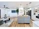 A modern kitchen with a central island and an open floor plan that flows into the living area at 609 Brockway Ave, Orlando, FL 32807