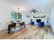Open living room with a brick fireplace, large windows, and vinyl flooring at 609 Brockway Ave, Orlando, FL 32807