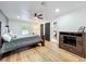 Inviting bedroom with a ceiling fan, hardwood floors, and a view of the bathroom through the doorway at 609 Brockway Ave, Orlando, FL 32807