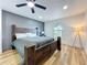 Comfortable bedroom featuring a dark wood bed, a gray accent wall, and a view of the front yard at 609 Brockway Ave, Orlando, FL 32807