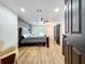 Spacious main bedroom featuring a large bed, hardwood floors, a ceiling fan, and a neutral color palette at 609 Brockway Ave, Orlando, FL 32807