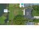 Aerial view of the home and manicured grounds, including private boat dock at 641 Virginia Dr, Winter Park, FL 32789