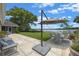 Backyard featuring a patio, dining set, large shade umbrella, and views of the lake at 641 Virginia Dr, Winter Park, FL 32789