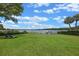 Expansive backyard with lush green lawn leading to the tranquil lake, perfect for outdoor relaxation and waterfront enjoyment at 641 Virginia Dr, Winter Park, FL 32789