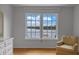 Bedroom featuring large windows offering beautiful lake views and a comfortable chair at 641 Virginia Dr, Winter Park, FL 32789