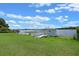 Quaint boathouse on the lakefront with a wooden walkway and lush green lawn at 641 Virginia Dr, Winter Park, FL 32789
