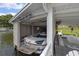 Boathouse featuring a boat lift, boat, fan, and shark decor at 641 Virginia Dr, Winter Park, FL 32789