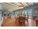 Open floor plan with dining area featuring stylish lighting and water views through large windows at 641 Virginia Dr, Winter Park, FL 32789
