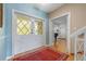 Bright foyer with hardwood floors, glass-paneled doors, and a glimpse of the staircase at 641 Virginia Dr, Winter Park, FL 32789