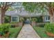 Home exterior featuring a manicured yard, brick facade and a blue front door at 641 Virginia Dr, Winter Park, FL 32789