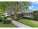 Well-maintained home with manicured lawn, mature trees, and a brick facade at 641 Virginia Dr, Winter Park, FL 32789