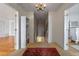 Hallway with a chandelier and beautiful hardwood floors leading to other rooms in the house at 641 Virginia Dr, Winter Park, FL 32789