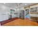 Bright kitchen with white cabinets, stainless steel appliances, and adjacent desk area at 641 Virginia Dr, Winter Park, FL 32789