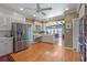 Open kitchen with stainless steel appliances, and ample cabinet space with view into dining area at 641 Virginia Dr, Winter Park, FL 32789