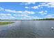 Scenic view of the expansive lake with clear skies and lush vegetation along the shoreline at 641 Virginia Dr, Winter Park, FL 32789