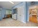 Large laundry room with modern washer and dryer units, ample counter space, and stylish blue walls at 641 Virginia Dr, Winter Park, FL 32789