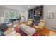 Inviting living room featuring a bay window, piano, and ample seating at 641 Virginia Dr, Winter Park, FL 32789