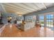 Spacious living room featuring exposed beam ceiling, fireplace, and views of the lake at 641 Virginia Dr, Winter Park, FL 32789