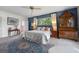 Cozy main bedroom with ample space, furniture, and natural light from a window at 641 Virginia Dr, Winter Park, FL 32789