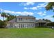 Expansive rear exterior with plush green lawn and multiple doors leading to the interior at 641 Virginia Dr, Winter Park, FL 32789