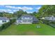 Aerial view of the backyard showing lush grass, lounge chairs, and private oasis at 641 Virginia Dr, Winter Park, FL 32789