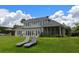 Spacious backyard with lawn chairs, screened porch, and multiple windows for natural light at 641 Virginia Dr, Winter Park, FL 32789