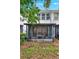 Backyard view of the property featuring a screened lanai and views of the lawn at 6931 Sperone St, Orlando, FL 32819
