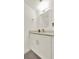 A well-lit half bathroom features a modern vanity and a decorative mirror at 6931 Sperone St, Orlando, FL 32819