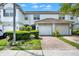 Well maintained home exterior featuring an attached two car garage and manicured landscaping at 6931 Sperone St, Orlando, FL 32819