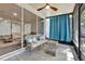 Screened lanai featuring neutral furniture, ceiling fan, and access to the backyard at 6931 Sperone St, Orlando, FL 32819