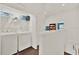 Bright laundry area with white washer and dryer, wood-look floors, and convenient shelving above at 6931 Sperone St, Orlando, FL 32819