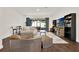 An open living room features wood floors, a large sliding glass door, with comfortable seating arrangements at 6931 Sperone St, Orlando, FL 32819