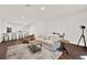 Open living room featuring hardwood floors, a comfortable sofa, and modern décor at 6931 Sperone St, Orlando, FL 32819