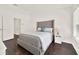 Bright bedroom featuring a large bed, hardwood floors, and plenty of closet space at 6931 Sperone St, Orlando, FL 32819