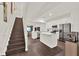 Modern open floorplan featuring the living room, kitchen, and wooden staircase at 6931 Sperone St, Orlando, FL 32819