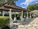 Beautiful shaded pergola with stone columns and a tiled floor, perfect for relaxing outdoors at 6931 Sperone St, Orlando, FL 32819