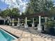 A shaded poolside pergola with comfortable seating and a tiled patio surrounds the community pool at 6931 Sperone St, Orlando, FL 32819