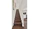 Wooden staircase featuring white banisters with a view to the living room below at 6931 Sperone St, Orlando, FL 32819