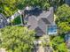 Aerial view of a beautiful house featuring a screened-in pool and a manicured lawn at 704 Forest View Ct, Winter Springs, FL 32708