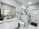 Modern bathroom featuring double sinks, marble tile, and a glass shower at 704 Forest View Ct, Winter Springs, FL 32708