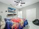 Bright bedroom featuring a ceiling fan, TV, and closet at 704 Forest View Ct, Winter Springs, FL 32708