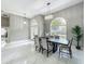 Open-concept dining space with elegant light fixtures, tile floors and lots of natural light at 704 Forest View Ct, Winter Springs, FL 32708