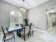 Formal dining room with dark wood table, elegant chandelier and views to the exterior at 704 Forest View Ct, Winter Springs, FL 32708