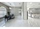 Bright dining room with marble floors, decorative chandelier and views into the kitchen at 704 Forest View Ct, Winter Springs, FL 32708