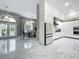 Spacious foyer featuring a dining room, luxury floors, and a modern kitchen at 704 Forest View Ct, Winter Springs, FL 32708
