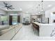 Spacious open-concept layout with a modern kitchen island and bar seating, seamlessly flowing into the living and dining areas at 704 Forest View Ct, Winter Springs, FL 32708