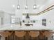 Bright open-concept kitchen featuring a large island with bar seating, sleek white cabinetry, and modern appliances for convenient living at 704 Forest View Ct, Winter Springs, FL 32708