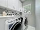 Well-equipped laundry area with modern washer and dryer, plus storage at 704 Forest View Ct, Winter Springs, FL 32708