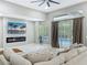 Bright living room featuring a fireplace, a large window with a view of the pool, and stylish decor, creating a comfortable atmosphere at 704 Forest View Ct, Winter Springs, FL 32708