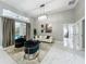 Comfortable living area with modern chandelier and white marble tile flooring throughout the home at 704 Forest View Ct, Winter Springs, FL 32708